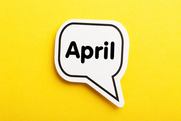 April Speech Bubble Isolated Yellow Background — Stock Photo, Image