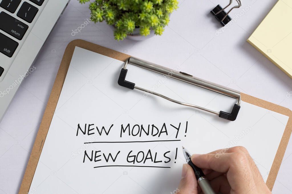 New Monday New Goals Concept on office desktop top view with office supplies.
