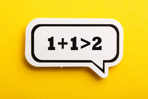 Synergy One One More Two Speech Bubble Isolated Yellow Background — Stock Photo, Image