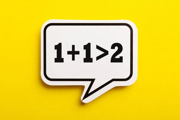 Synergy One One More Two Speech Bubble Isolated Yellow Background — Stock Photo, Image