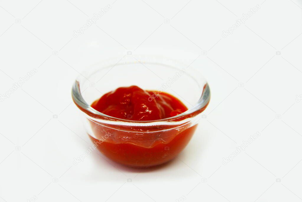 ketchup in a saucer on a white background