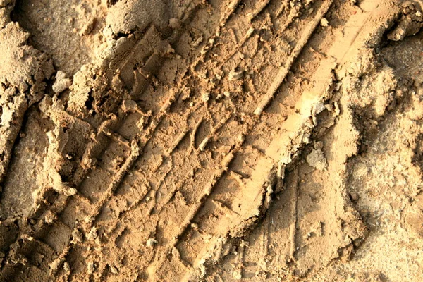 car wheel tracks in the mud close-up, background