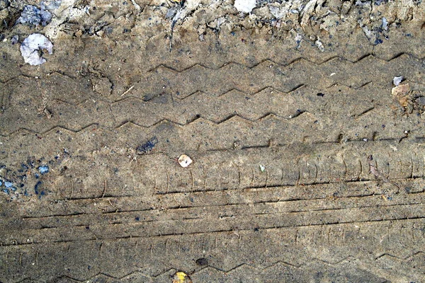 car wheel tracks in the mud close-up, background
