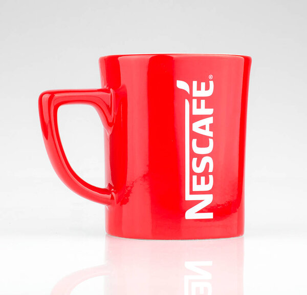 Lahore: Promotional red Nescafe mug on gray background 