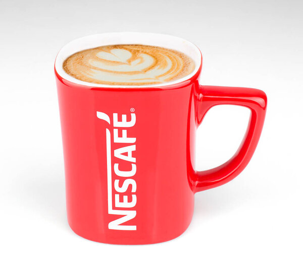 Lahore: Promotional red Nescafe mug on gray background 