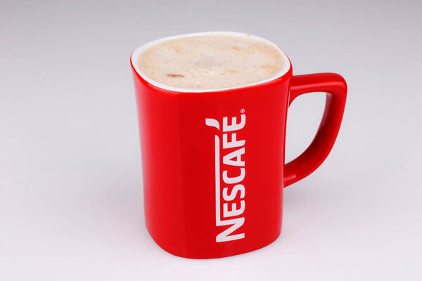 Lahore: Promotional red Nescafe mug on gray background 
