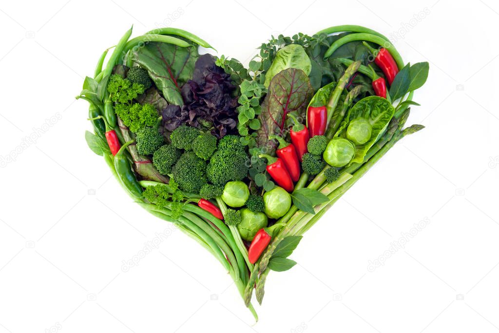 Various vegetables in a heart shape isolated on a white background