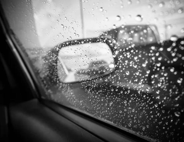 Raindrops on the car rearview mirror , Image black and white tone
