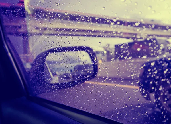 Raindrops on the car rearview mirror