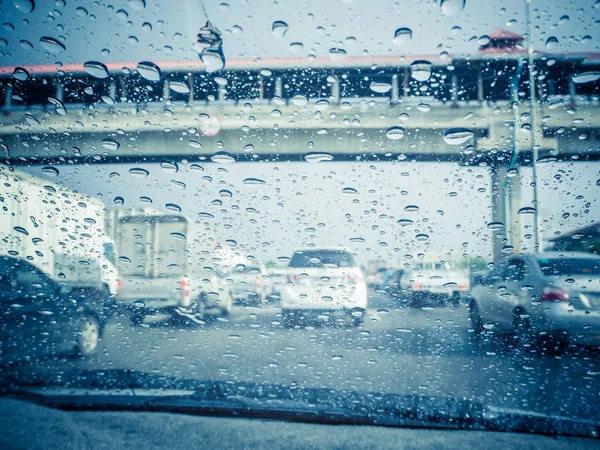 Traffic view from car windscreen in rain.Driving in rain