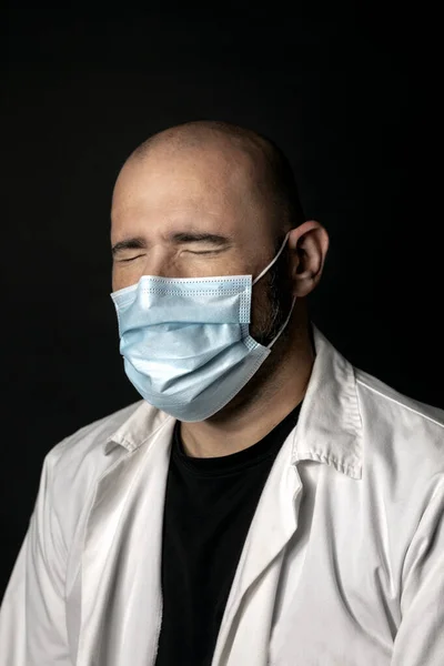 Doctor thinking with closed eyes and black background