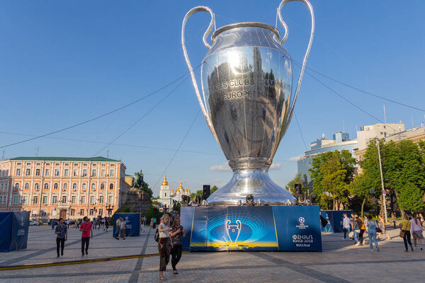 Kiev, Ukraine - May 24, 2018: Fans near the giant layout of the UEFA Champions League Cup at Sofia Square