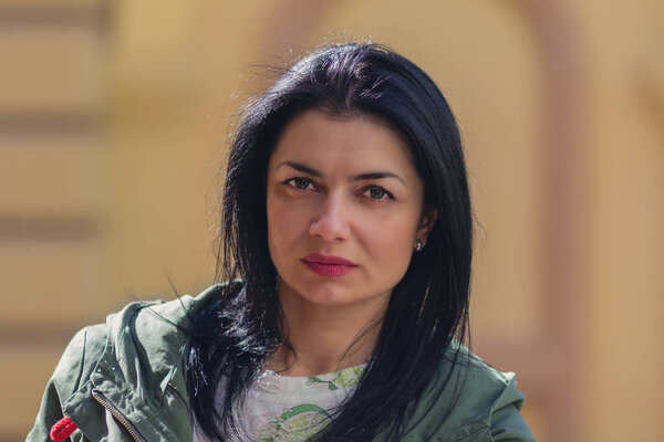 Portrait of the serious woman in the street. People