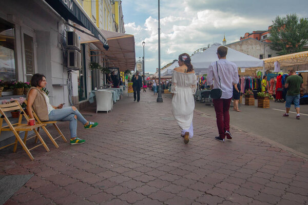 Kiev, Ukraine - July 13, 2018: Townspeople and tourists near the fair and street cafe