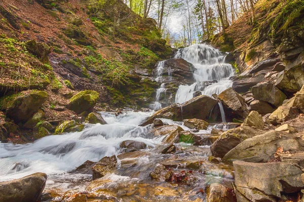 Mountain waterfall spikes and wet stones. Carpathians