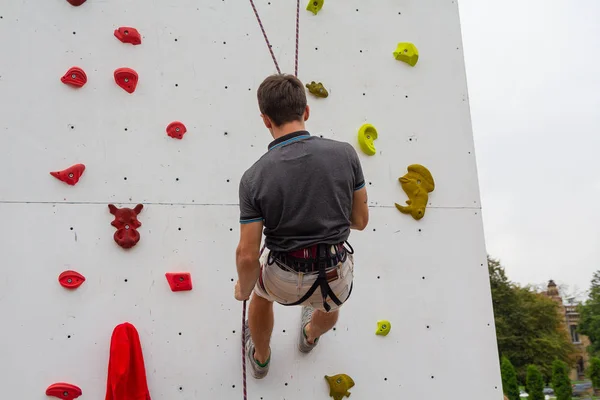 Man climbing artificial boulders during exercise. Rock climbing