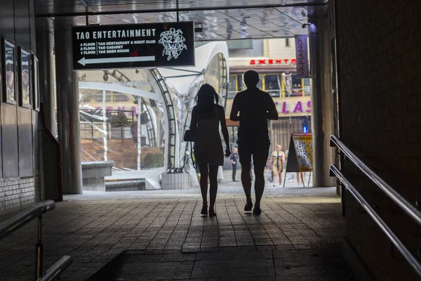 Kiev, Ucrania - 18 de junio de 2016: Siluetas de parejas jóvenes que pasan por un túnel en dirección al centro comercial — Foto de Stock