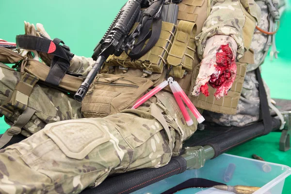 Manichino di un combattente ferito con una ferita grave su una barella. Medicina — Foto Stock