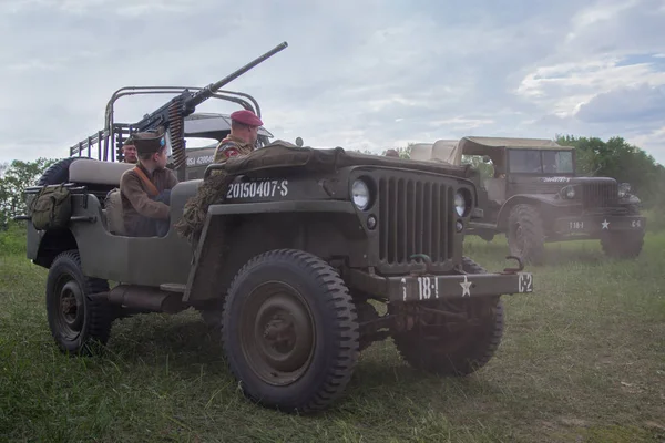 Kiev, Ukraine - May 09, 2018: Mens and a boy in the form of American soldiers and an American army jeep at a historical reconstruction to celebrate the anniversary of victory in World War II