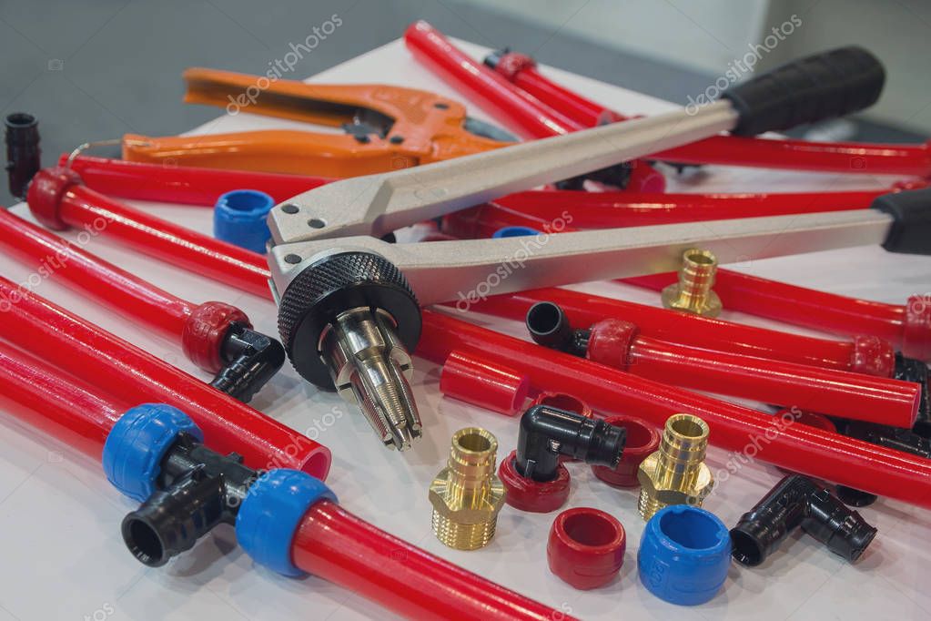 Water pipes PEX and mounting tools on the table. Plumbing