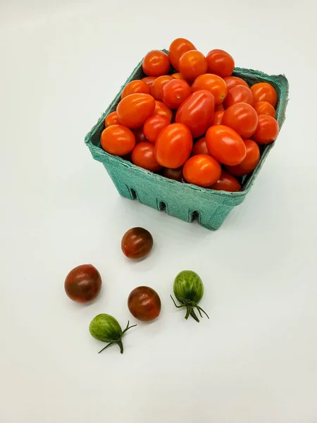 Fresh tomatoes in box. Small organic tomatoes