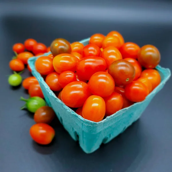 Fresh tomatoes in box. Small organic tomatoes