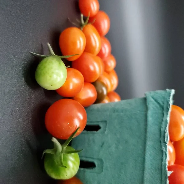 Fresh tomatoes in box. Small organic tomatoes