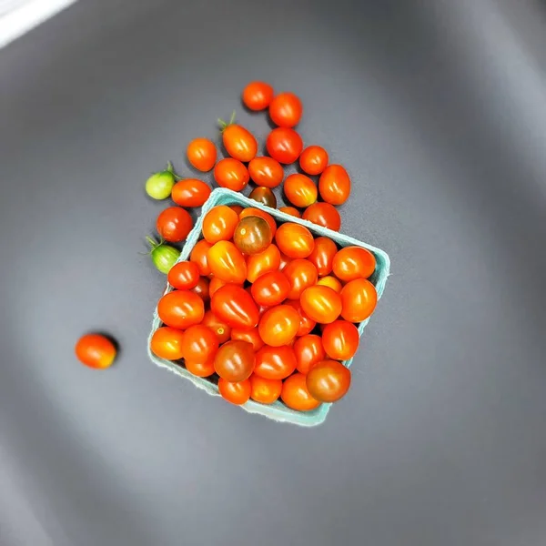 Fresh tomatoes in box. Small organic tomatoes