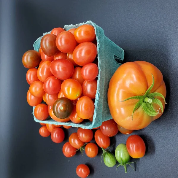 Fresh tomatoes in box. Small organic tomatoes