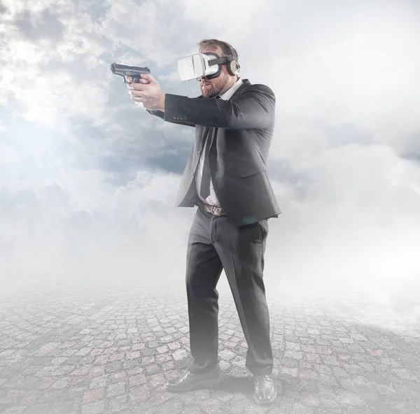 Businessman is playing a game wearing virtual reality glasses and holding a gun — Stock Photo, Image