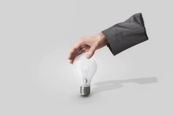 Businessman hand grapping light bulb — Stock Photo, Image