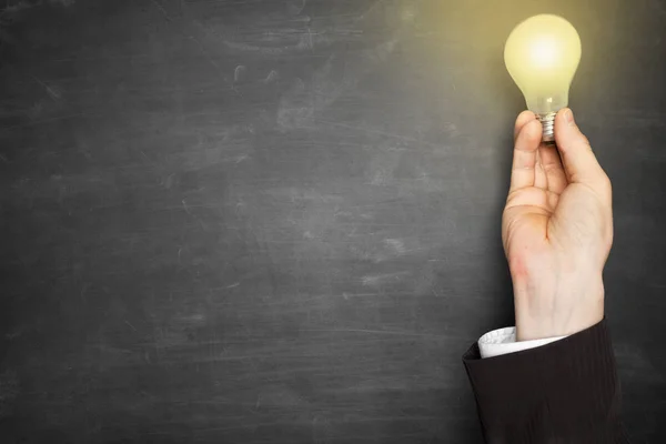 Businessman hand holding a lightbulb — Stock Photo, Image