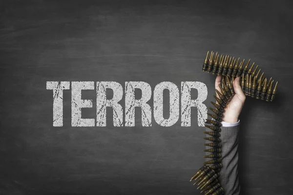 Terror text on blackboard with businessman hand holding ammunition — Stock Photo, Image