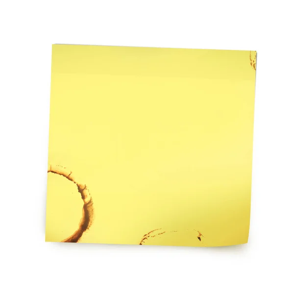 Gele herinnering nota papier met koffie vlek — Stockfoto