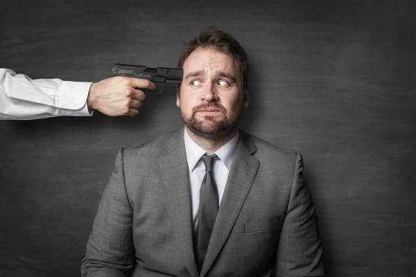 Злой босс приставил пистолет к голове бизнесмена — стоковое фото