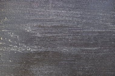 Koyu kahverengi soluk ahşap dokusu - görünür çatlaklar ve aşınma izleri ile yarı matte cila ile boyanmış bir bank tahtası yakın çekim