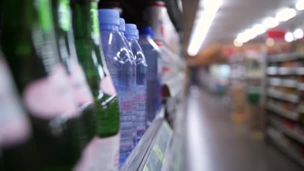 Woman Shopper Taking Bottle of Water in Supermarket. Vegan Girl Buying Drink. 4K Slowmotion. — Stock Video