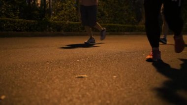 Parkta çalışan insanlar. Görünüm koşucular Legs--dan zemin seviyesinin üzerinde. 16 Kasım 2018 - Bangkok, Tayland. 4k Slowmotion.