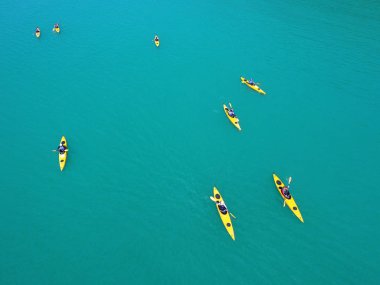 İnsanlar kürek çekmeye kayaklar üzerinde grubudur. Açık denizde kano gezisi. Phuket, Tayland.