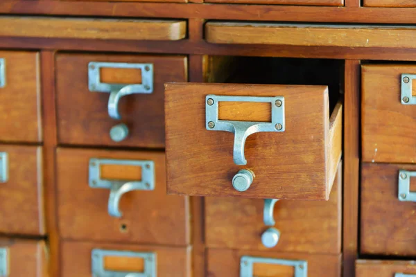 Old wooden vintage Medicine drawer cabinet. Catalog file cabinet