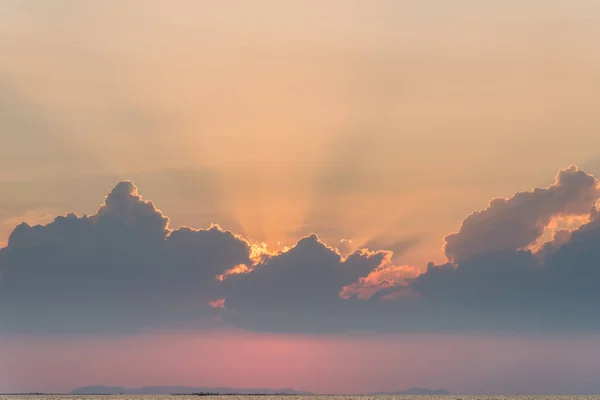 Beautiful dramatic sky clouds with light rays at sunset. Natural landscape for background