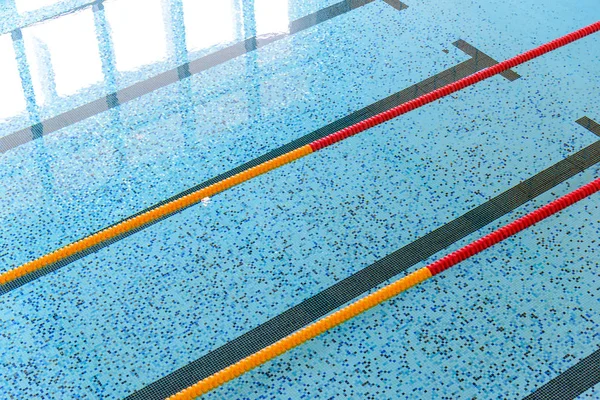 Top view of indoor swimming pool with race tracks or lane marker. Sport concept