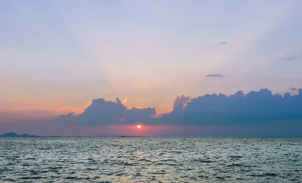 Beautiful dramatic sky clouds with light rays over the sea at sunset time. Natural landscape for background — Stock Photo, Image