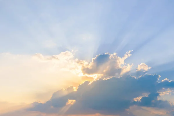 Beautiful dramatic sky clouds with light rays at sunset. Natural landscape for background