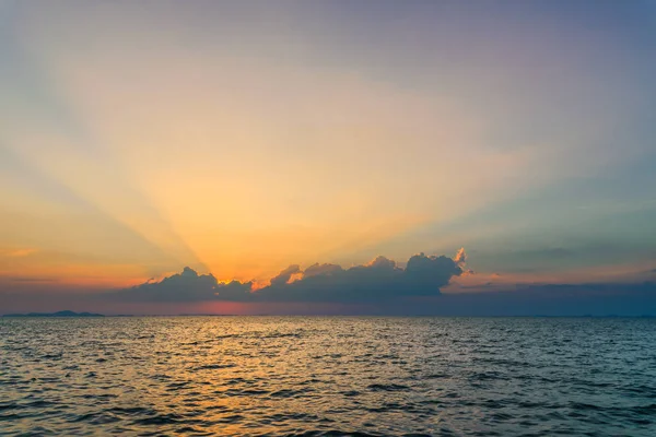 Beautiful dramatic sky clouds with light rays over the sea at sunset time. Natural landscape for background — Stock Photo, Image