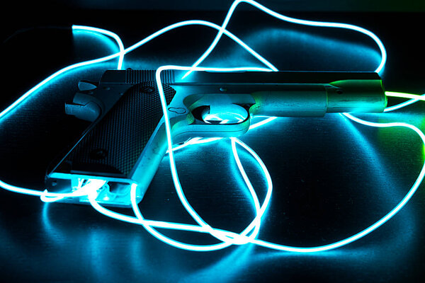 A closer look of a famous gun with blue neon cables