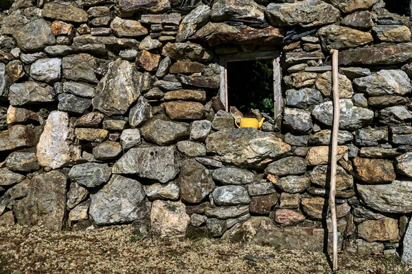 Vintage stone wall. Elder\'s stick and old teapot in front of vintage stone wall, County Wicklow, Ireland