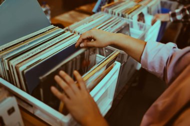 Kadın bir müzik mağazasında bir vinil kayıt seçme