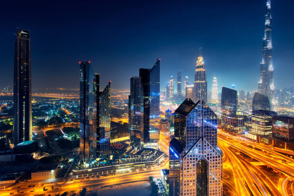 Dubai skyline at night, aerial top view to downtown city center landmarks. Famous viewpoint, United Arab Emirates