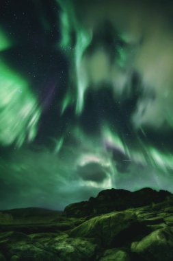 Northern Lights, Aurora Borealis in Kola Peninsula at night sky illuminated green. Murmansk region, Russia clipart